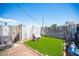 Backyard featuring artificial turf, a dog house, and a partially fenced perimeter at 4412 Baxter Pl, Las Vegas, NV 89107
