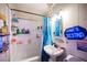Compact bathroom featuring a shower-tub combination and decorative accents at 4412 Baxter Pl, Las Vegas, NV 89107