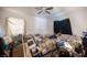 Bedroom features a ceiling fan, natural light, and neutral-toned walls at 4412 Baxter Pl, Las Vegas, NV 89107