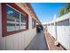 Side of house shows a narrow passageway between the fence and the home's exterior wall at 4412 Baxter Pl, Las Vegas, NV 89107