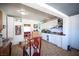 Open kitchen with white cabinets, tile floors, and a dining table with chairs at 4412 Baxter Pl, Las Vegas, NV 89107