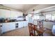 Bright kitchen with white cabinets, tile floors, and natural light from windows at 4412 Baxter Pl, Las Vegas, NV 89107