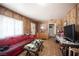 Inviting living room with paneled walls, tile floors, and a comfortable red sofa at 4412 Baxter Pl, Las Vegas, NV 89107