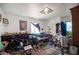 A cluttered living room with personal items, furniture and light from a window at 4412 Baxter Pl, Las Vegas, NV 89107