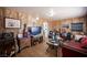 Cozy living room with wood-paneled walls and eclectic decor at 4412 Baxter Pl, Las Vegas, NV 89107