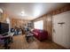 Cozy living room with paneled walls, tile floors, and a comfortable red sofa at 4412 Baxter Pl, Las Vegas, NV 89107