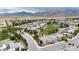 Expansive aerial view of a golf course community with single-story homes and mountain views at 4844 E Cactus Canyon Dr, Pahrump, NV 89061