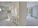 Elegant bathroom featuring double sinks, stylish cabinets, and a doorway to the carpeted bedroom at 4844 E Cactus Canyon Dr, Pahrump, NV 89061