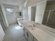 Bright bathroom featuring double vanity, modern fixtures, and a view of the shower at 4844 E Cactus Canyon Dr, Pahrump, NV 89061