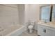 Bright bathroom featuring white vanity, tub with shower, and neutral flooring at 4844 E Cactus Canyon Dr, Pahrump, NV 89061
