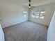 Bright bedroom featuring three large windows and neutral carpeting at 4844 E Cactus Canyon Dr, Pahrump, NV 89061