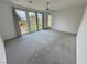 Bright bedroom with large windows offering serene outdoor views, neutral carpet, and modern ceiling fan at 4844 E Cactus Canyon Dr, Pahrump, NV 89061