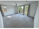 Spacious bedroom with carpet flooring, ceiling fan, and sliding glass doors to the outdoors at 4844 E Cactus Canyon Dr, Pahrump, NV 89061