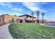Modern community building with large windows, palm trees, and well-maintained lawn at 4844 E Cactus Canyon Dr, Pahrump, NV 89061