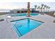 Community pool and spa surrounded by ample seating and desert landscaping at 4844 E Cactus Canyon Dr, Pahrump, NV 89061