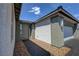Modern home featuring front door, paved walkway, and attached garage at 4844 E Cactus Canyon Dr, Pahrump, NV 89061
