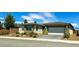Attractive single-story home with a two-car garage, complemented by desert landscaping and a paved driveway at 4844 E Cactus Canyon Dr, Pahrump, NV 89061