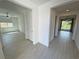 Open hallway leads to bedrooms and sun-filled living area with ceramic tile floors at 4844 E Cactus Canyon Dr, Pahrump, NV 89061