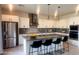 Modern kitchen with sleek white cabinets, stainless steel appliances, and a spacious island with bar seating at 4844 E Cactus Canyon Dr, Pahrump, NV 89061