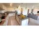 Bright, open-concept kitchen featuring a center island with seating, modern appliances, and stylish pendant lighting at 4844 E Cactus Canyon Dr, Pahrump, NV 89061