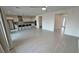 Spacious living room with tile flooring, ceiling fan, and views into the kitchen at 4844 E Cactus Canyon Dr, Pahrump, NV 89061