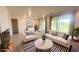 Cozy living room with neutral tones, comfortable seating, and sliding doors leading to an outdoor space at 4844 E Cactus Canyon Dr, Pahrump, NV 89061