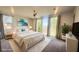 Serene bedroom featuring soft lighting, a comfortable bed, and large windows with a view of the outdoors at 4844 E Cactus Canyon Dr, Pahrump, NV 89061