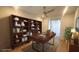 Spacious home office with custom built-in shelving and a ceiling fan at 4844 E Cactus Canyon Dr, Pahrump, NV 89061