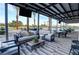 Inviting covered outdoor patio with comfortable seating, tv and picturesque views of the community pool and grounds at 4844 E Cactus Canyon Dr, Pahrump, NV 89061