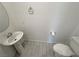 Powder room featuring toilet, pedestal sink, oval mirror and ceramic tile flooring at 4844 E Cactus Canyon Dr, Pahrump, NV 89061