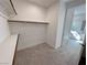 Walk-in closet with carpeted floor, shelving and view of attached bathroom at 4844 E Cactus Canyon Dr, Pahrump, NV 89061