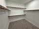 Bright walk-in closet with built-in shelving and carpeted floor at 4844 E Cactus Canyon Dr, Pahrump, NV 89061