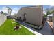Backyard featuring a green lawn, stone path, and a view of the house at 4940 Mascaro Dr, Las Vegas, NV 89122