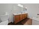 Well-lit bathroom with double vanity, wood cabinets, and tile flooring for an elegant touch at 4940 Mascaro Dr, Las Vegas, NV 89122