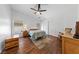 Bright bedroom with wood floors, ceiling fan, and large window at 4940 Mascaro Dr, Las Vegas, NV 89122