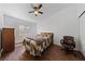 Bedroom with wood floor, ceiling fan, and large window for natural light at 4940 Mascaro Dr, Las Vegas, NV 89122