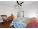 Bedroom featuring wood floors, ceiling fan, and blue quilt bedding at 4940 Mascaro Dr, Las Vegas, NV 89122