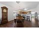 Dining room with dark wood floors, adjacent to kitchen; decorative grandfather clock in the corner at 4940 Mascaro Dr, Las Vegas, NV 89122