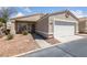 Charming single-story home featuring a two-car garage, front door, and low maintenance landscaping at 4940 Mascaro Dr, Las Vegas, NV 89122