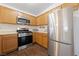 Efficient kitchen featuring stainless steel appliances, wood cabinetry, and a gas range at 4940 Mascaro Dr, Las Vegas, NV 89122