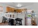 Bright eat-in kitchen with stainless steel appliances, wood cabinets, and a breakfast bar at 4940 Mascaro Dr, Las Vegas, NV 89122
