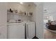 Bright laundry room featuring a side-by-side washer and dryer and ample shelving at 4940 Mascaro Dr, Las Vegas, NV 89122