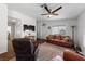 Open-concept living room with hardwood floors and a ceiling fan provides a comfortable area at 4940 Mascaro Dr, Las Vegas, NV 89122