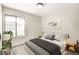This virtually staged bedroom features a large window, bed, and stylish decor at 5020 Village Dr, Las Vegas, NV 89142