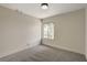 This empty bedroom has neutral paint, new carpet, and a large window at 5020 Village Dr, Las Vegas, NV 89142