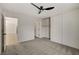 This bedroom features neutral paint, new carpet, a ceiling fan, and sliding-door closet at 5020 Village Dr, Las Vegas, NV 89142