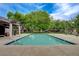 Community pool featuring a shaded area and mature trees nearby at 5020 Village Dr, Las Vegas, NV 89142