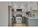 Stylish kitchen with stainless steel appliances, gray and white cabinets, and sleek countertops at 5020 Village Dr, Las Vegas, NV 89142