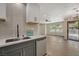 A modern kitchen featuring stainless steel appliances, quartz countertops, and a sink with a sleek faucet at 5020 Village Dr, Las Vegas, NV 89142