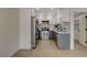 Updated kitchen featuring stainless steel appliances, two-tone cabinets, tiled backsplash, and wood-look flooring at 5020 Village Dr, Las Vegas, NV 89142